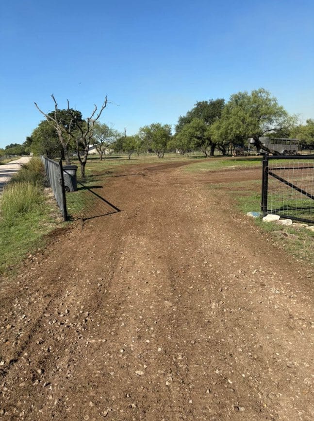 Graded dirt drive through a ranch gate