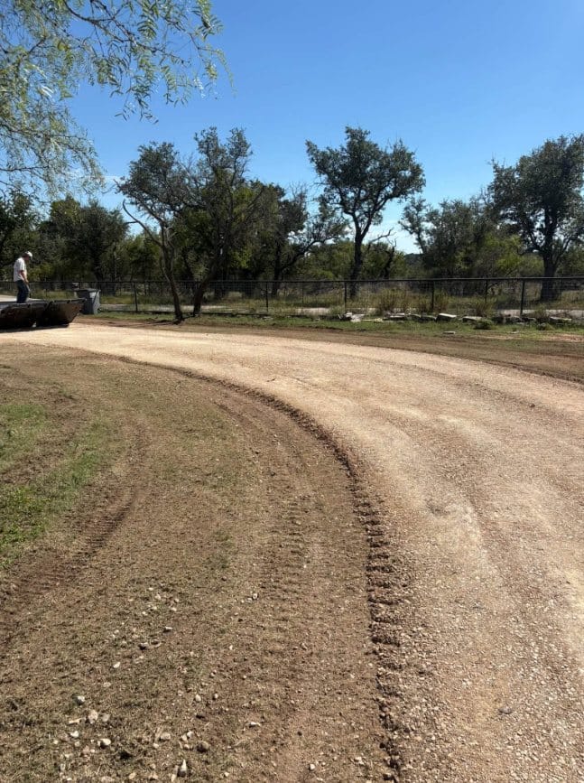 Finished gravel drive along a pipe fence
