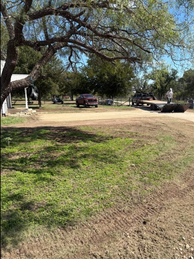 Gravel drive with the yard cleaned up beside it