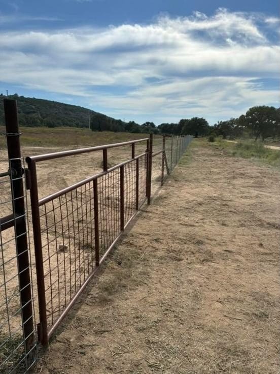 Pipe fence with wire panels along a pasture