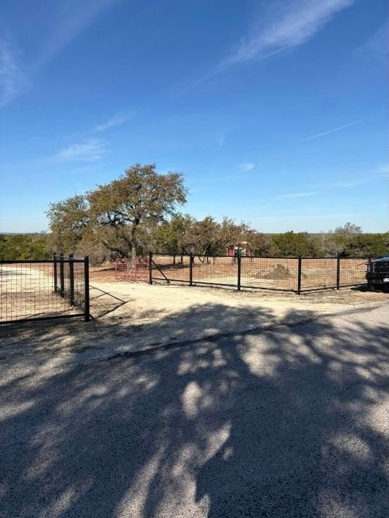Black pipe fence and gate at a property entrance